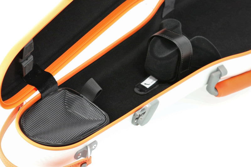 Close-up of an open hard instrument case with a white exterior, bright orange trim, black interior padding, and a black strap or accessory holder inside.