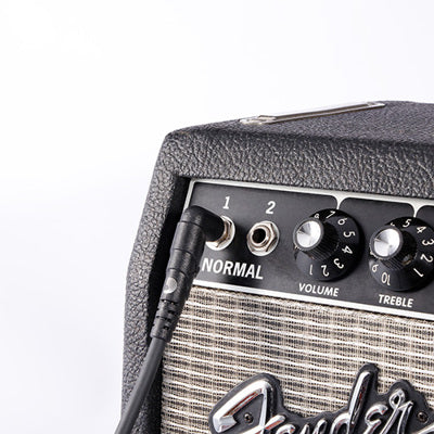 Fender guitar amplifier with a cable plugged into the input jack on a white background