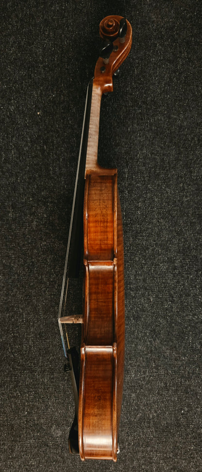 Side view of the violin on a grey background