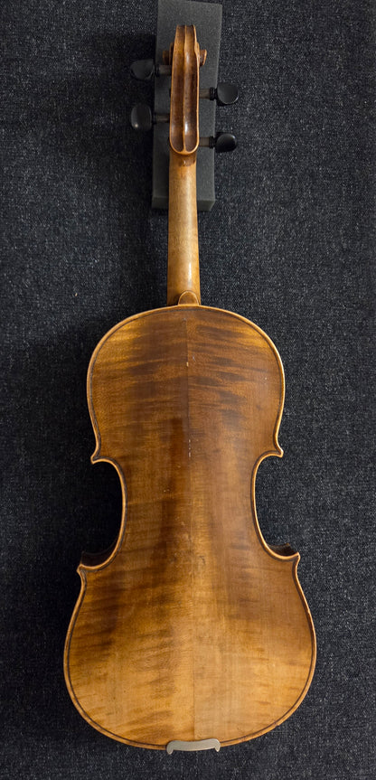 Back of antique violin on a grey background