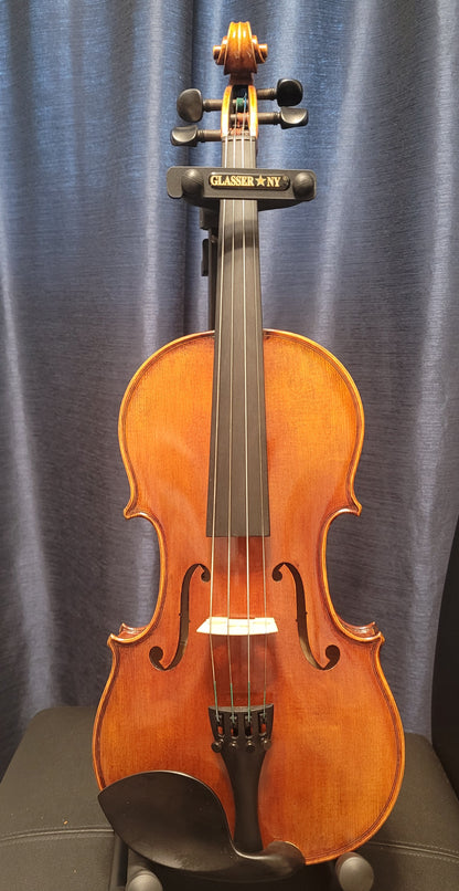 Violin on a stand against a gray curtain background
