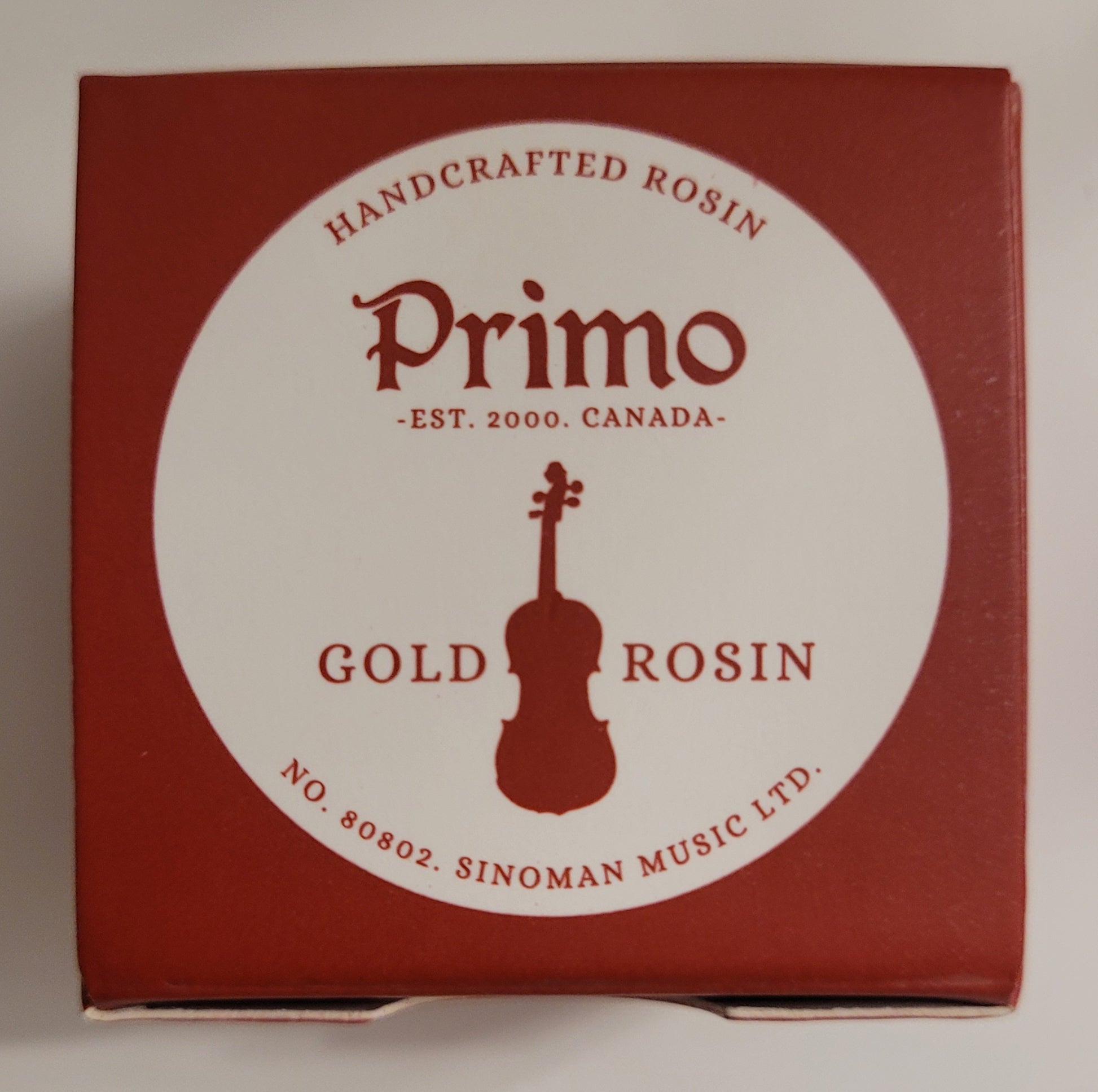 Red box of Primo Gold Rosin with a violin illustration on a white background