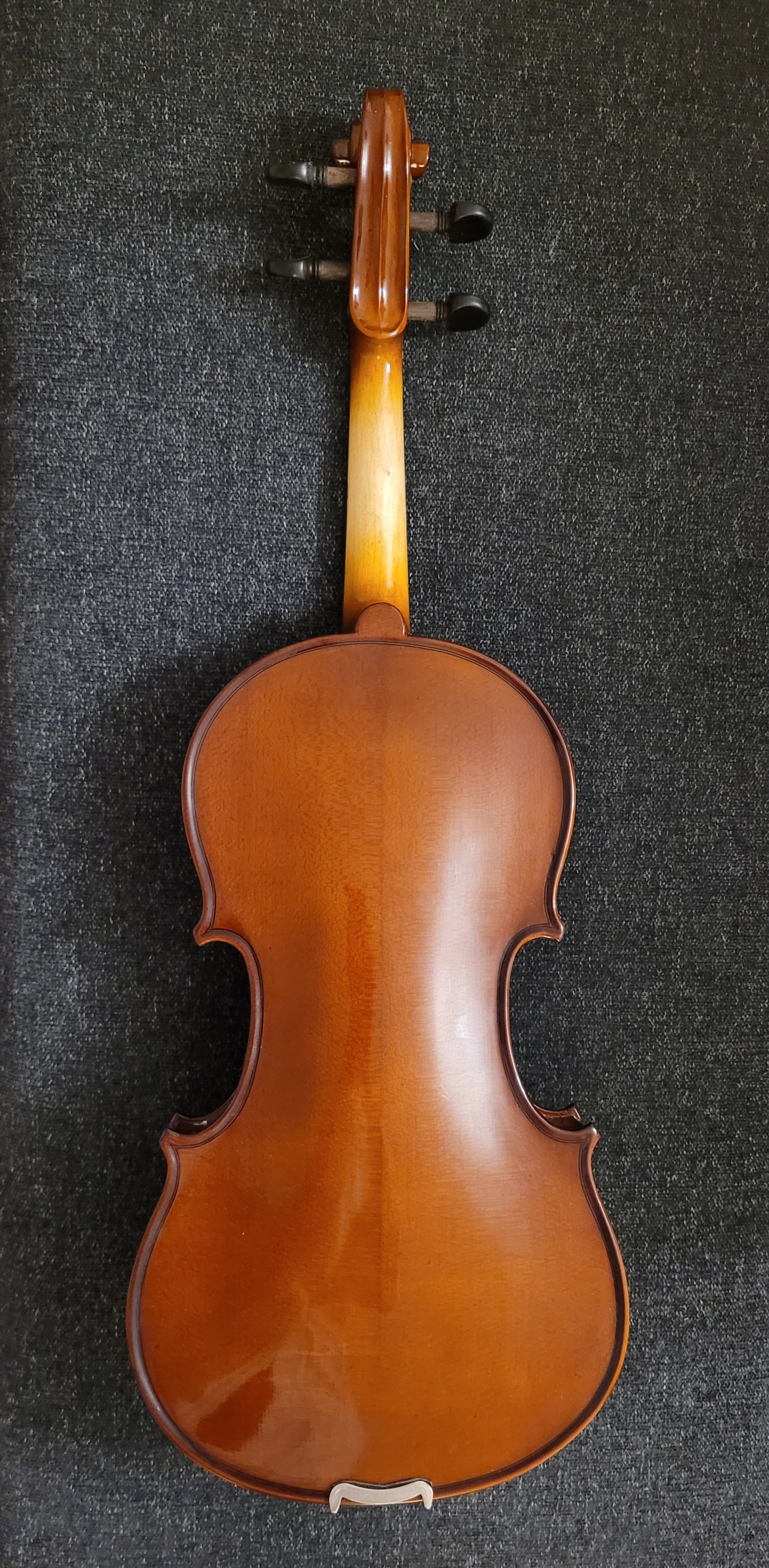 Violin on a dark textured surface